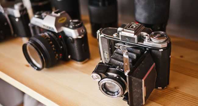 Before: dull, soft photo of vintage cameras